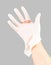 Broken white latex surgeon medical glove on caucasian hand isolated on gray background