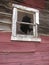 Broken Window on Abandoned Red Mining Cabin