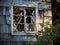 A broken window in the wall of a dilapidated and abandoned house.