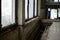 Broken windows and dismantled floor in the entrance of an old abandoned apartment building