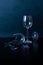 Broken wine glass blue black background closeup copy space