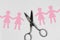 Broken women paper chain with scissors on white background - Bro