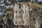 Broken wooden plate with letters and lichens