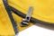 Broken zipper on yellow shirt jacket. Detail close-up photo