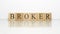 Broker name created from wooden letter cubes. finance and economy.
