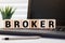 Broker word wooden cubes on the green background