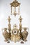 Bronze amphorae and clock on a white background, antique vases and clock studio photo, antique clock and two candelabras, antique