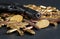 Bronze and brass gun bullets scattered on dark table, black pistol barrel, golden bitcoin coins near - illegal use of