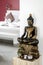 Bronze buddha statue interior design detail in modern asian home