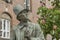 Bronze bust of the danish writer H C Andersen, sitting in front of a brick building in Copenhagen
