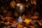 bronze chalice surrounded by scattered autumn leaves