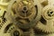 Bronze cog-wheels of old mechanism of clock by close up