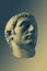 Bronze color gypsum copy of ancient statue of Germanicus Julius Caesar head for artists on brass background. Renaissance