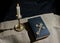 Bronze cross, burning candle and bible on the table