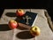 Bronze cross, holy bible and three apples on the table