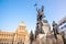 The bronze equestrian statue of St Wenceslas at the Wenceslas Square with historical Neorenaissance building of National