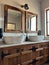 Bronze faucets over stone wash basins in the hotel bathroom