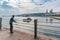 Bronze fisherman statue on pier