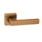 Bronze front door handle with a reddish tint on a square base and a straight handle