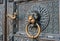 Bronze knocker in the shape of a lion`s head at the gate of the Cologne Cathedral, the most famous church in Germany.