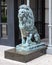 Bronze lion sculpture sitting on a granite pedestal in downtown Dallas, Texas.