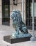 Bronze lion sculpture sitting on a granite pedestal in downtown Dallas, Texas.