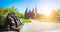 Bronze Lion statue in front of Holsten Gate - Panoramic shot of Holstentor and park, a city gate marking off the western