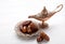 Bronze plate with dates and aladdin lamp on a white wooden background