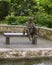 Bronze sculpture of a boy on a bench fishing by Gary Price at the Dallas Arboretum and Botanical Garden