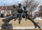 A bronze sculpture titled `Children Reading` by unknown artist located in the Dr. Glenn Mitchell Memorial Park in McKinney, Texas.