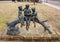 A bronze sculpture titled `Children Reading` by unknown artist located in the Dr. Glenn Mitchell Memorial Park in McKinney, Texas.