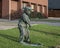 Bronze sculpture of a young boy golfing, located on the lawn of a business in Dallas, Texas.