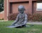 Bronze sculpture of a young girl reading a book on the lawn of a business in Dallas, Texas.