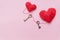 Bronze skeleton key and pink knitted hearts,antique rustic keys on pink background. Happy valentine`s day card.symbol of