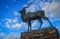 Bronze statue of antelope with large curled horns in the center of the capital of Namibia