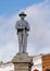 Bronze statue of a confederate soldier standing at parade rest atop a stone pedestal in Jefferson, Texas.