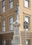 Bronze statue of a confederate soldier standing at parade rest atop a stone pedestal in Jefferson, Texas.