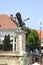 bronze statue of eagle with open wings holding sword in its claws at main gate of Buda fortress in Budapest, Hungary