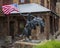 Bronze statue by Frederic Remington of a cowboy riding a rearing horse and carrying an American flag in Arlington, Texas.