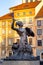 The bronze statue of Mermaid on the Old Town Market Square of Warsaw, surrounded by colorful old houses, Poland