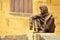 Bronze statue The onlooker by Gerard Auliac in Sarlat, France