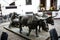 Bronze Statue of Oxen and their Driver pulling goods on wooden runners. The statue is in Funchal Madeira near the Market Hall