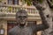 Bronze statue of Portuguese musician artist Zeca Afonso with a carnation flower on the hand in Belmonte, Portugal