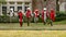 Bronze statue of six exuberant children running forward, dressed with Christmas scarves and hats in Dallas, Texas