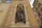 Bronze statue of St. Luke San Luca, detail of Orsanmichele church exterior in Florence, Italy