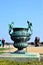 Bronze statue of three cherubs on the edge of a basin of the Bassin du Midi in the gardens of Versailles, in front of the west