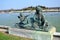 Bronze statue of three cherubs on the edge of a basin of the Bassin du Midi in the gardens of Versailles, in front of the west