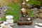 Bronze statue of Touching earth Buddha with balanced stones