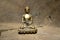 Bronze statue of Touching earth Buddha on wood