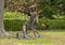 Bronze statue of a young barefooted girl petting a fox in a yard in Dallas, Texas